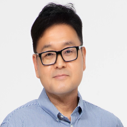Photographic headshot of Jeong Han Kim, a middle-aged Korean man wearing glasses